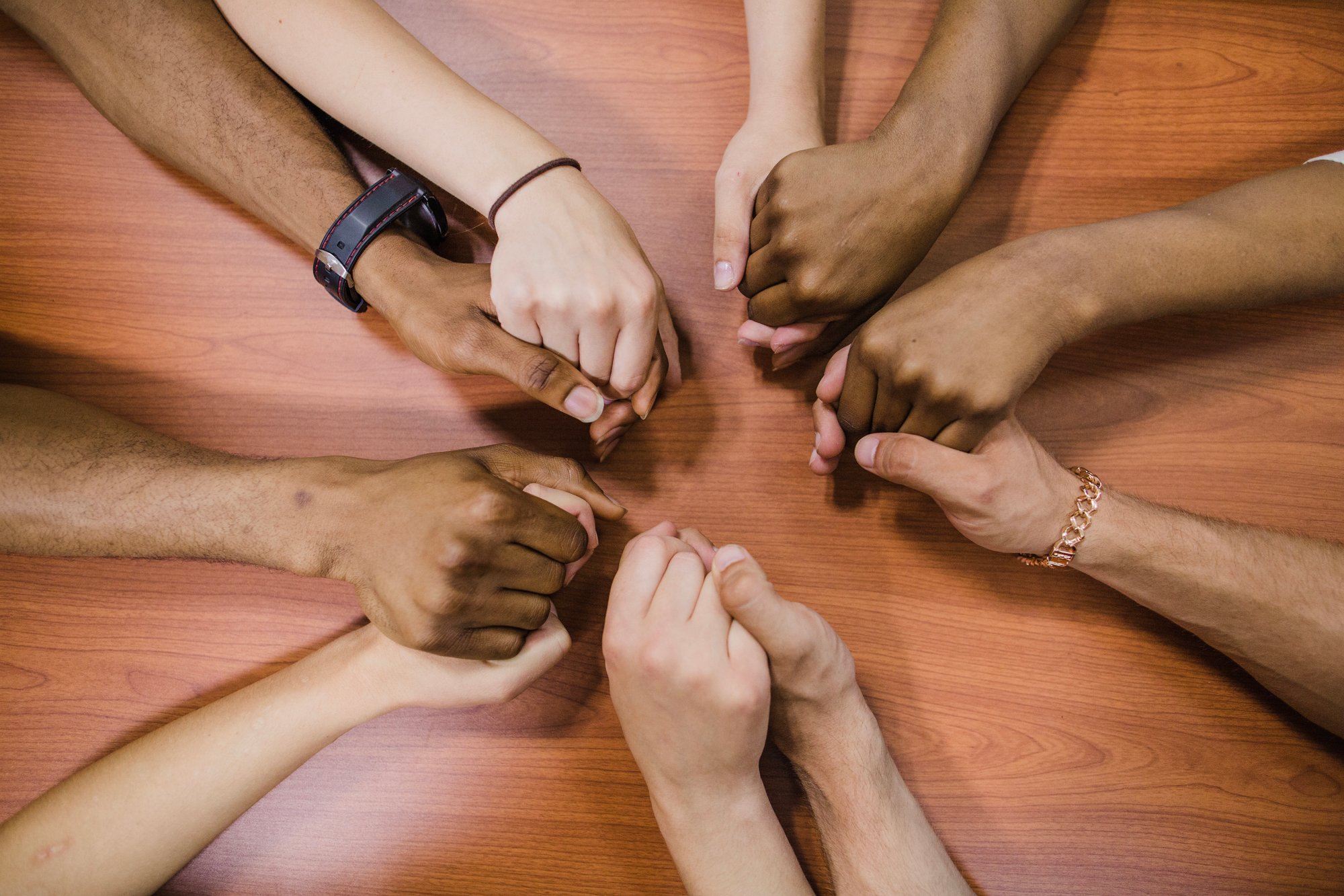people-holding-hands-table | Image by freepik people-holding-hands-table | Image by freepik
